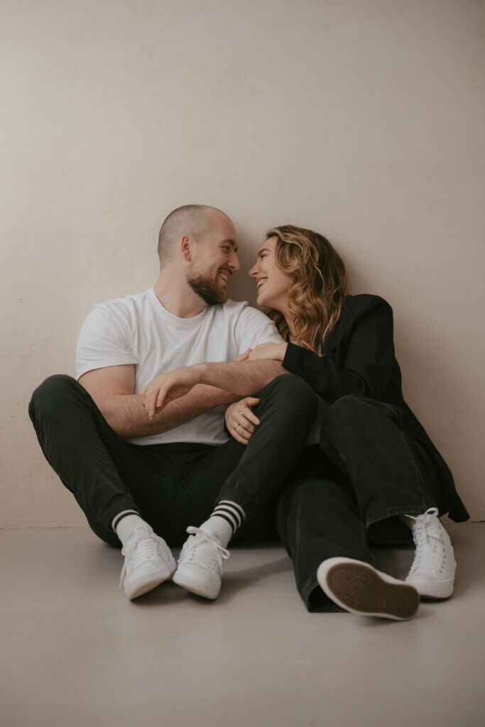 couple sitting next to each other on the floor